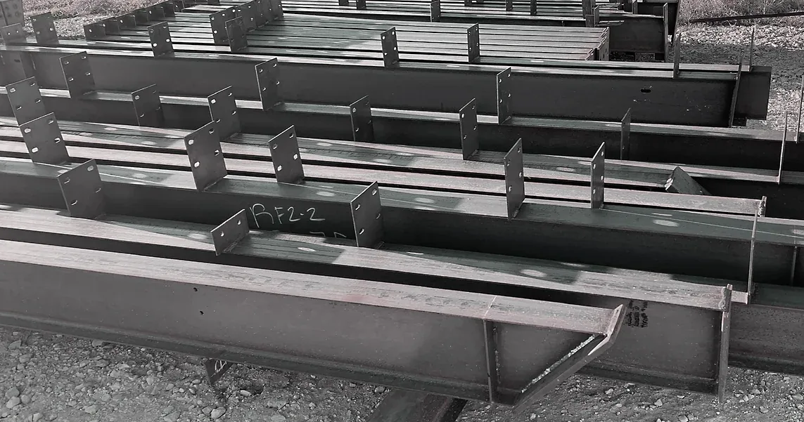 Steel fabrication in progress on the shop floor with plate being processed under overhead crane rails